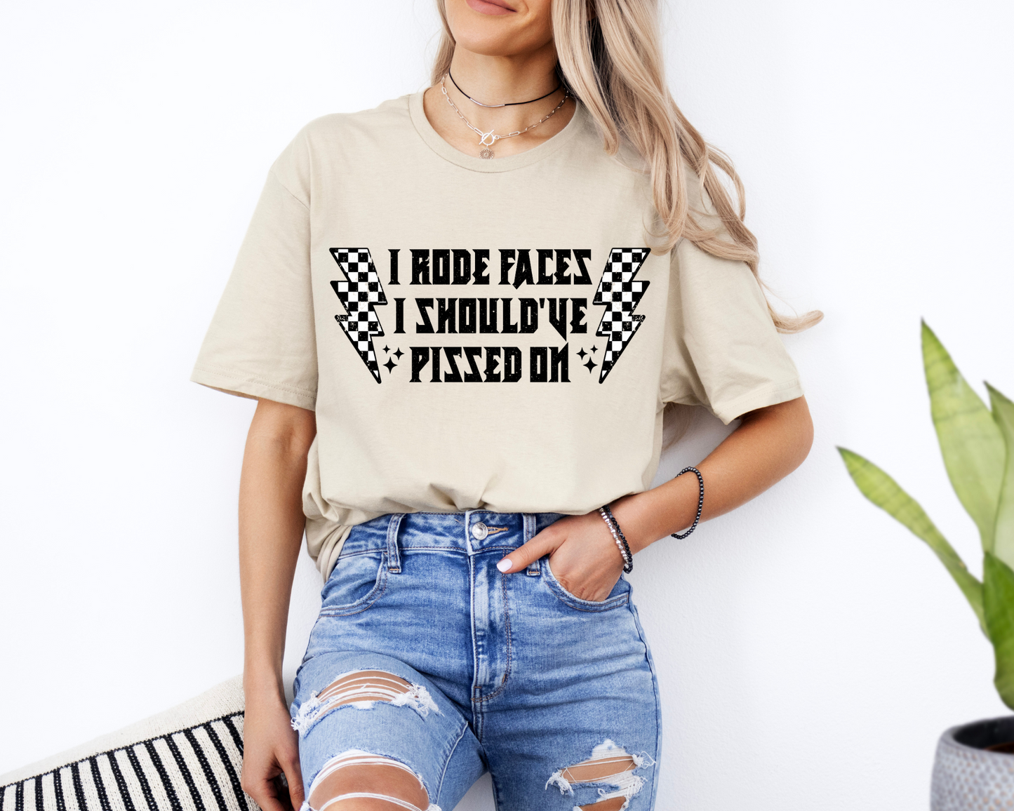 "I Rode Faces I Should've Pissed On" Graphic Tee – Checkered Lightning Bolt Design